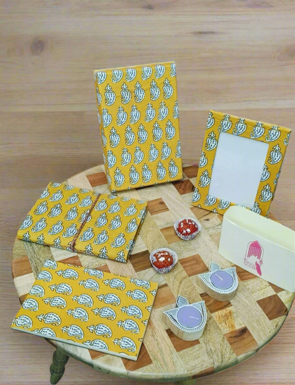 Gift Box with Work Desk Essential : 1 Diary, 1 Notepad, 1 Photoframe, 2 laddoo candles, 2 handblock candles