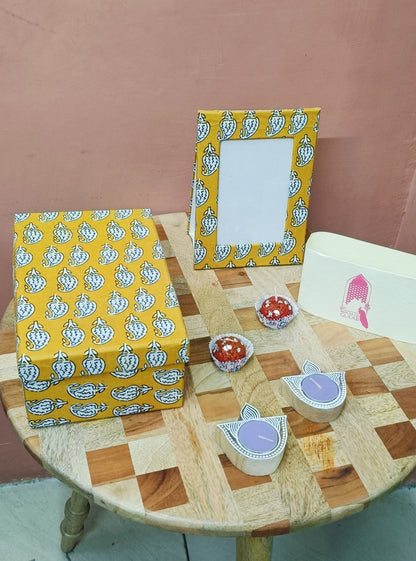 Gift Box with Work Desk Essential : 1 Diary, 1 Notepad, 1 Photoframe, 2 laddoo candles, 2 handblock candles